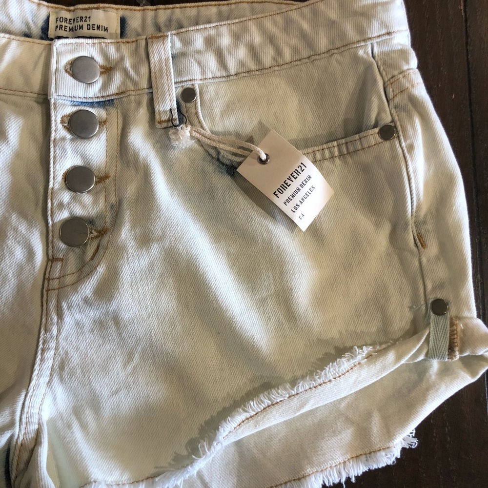 Light-wash distressed denim cutoff shorts